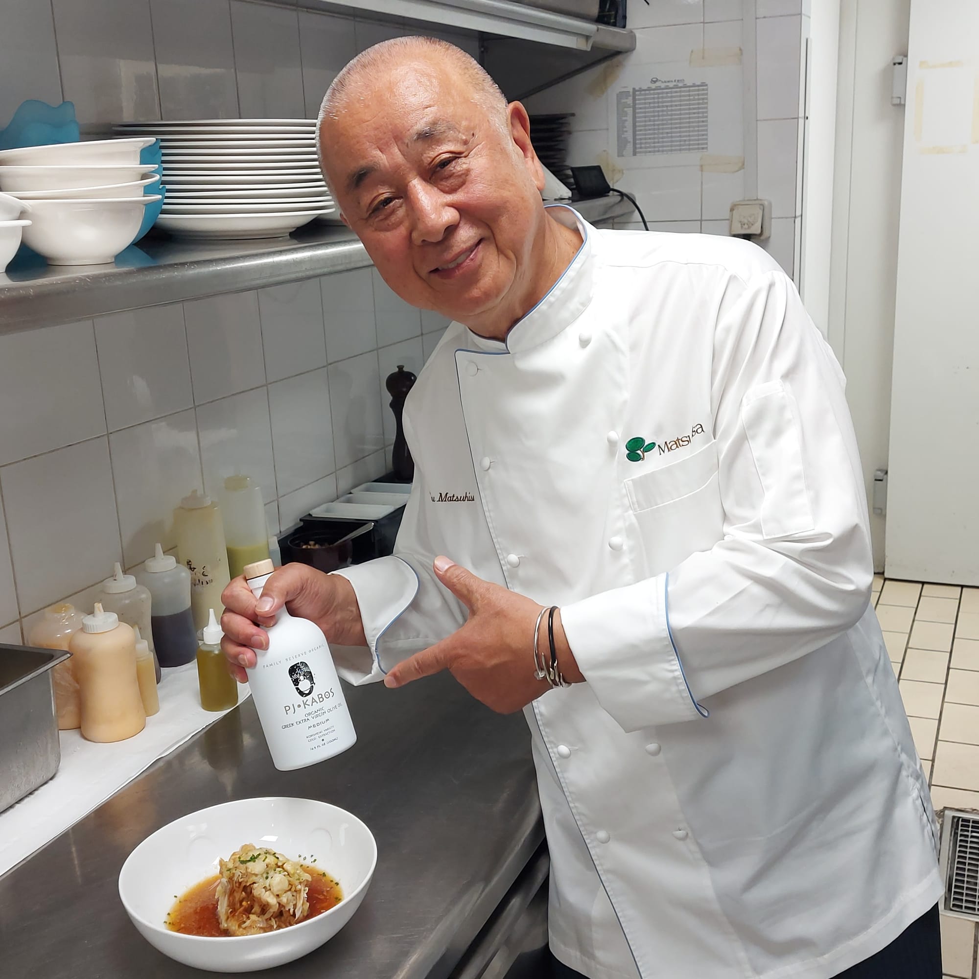 Chef Nobu Matsuhisa pointing to a bottle of PJ Kabos Family Reserve Organic – Medium – High Phenolic Extra Virgin Olive Oil; the EVOO he uses in his Nobu and Matsuhisa restaurants around the world.