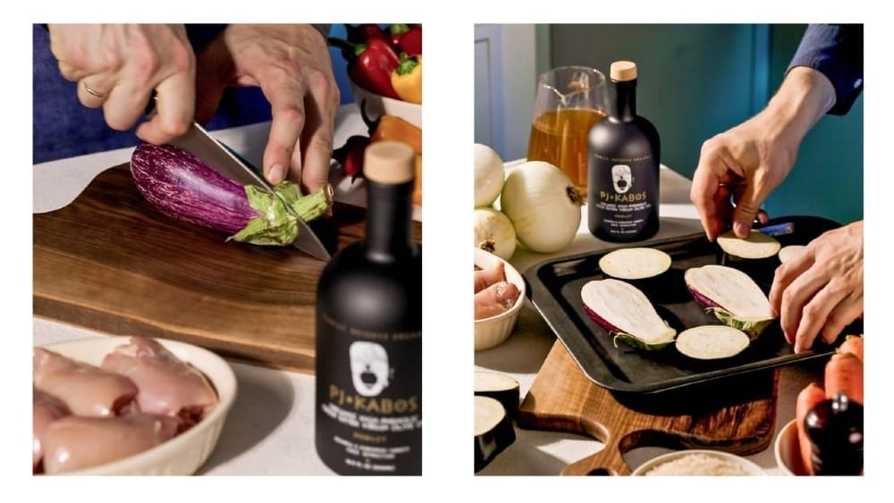 Eggplants being cut and put on a roasting pan. PJ Kabos Family Reserve Organic Robust Extra Virgin Olive Oil is shown.